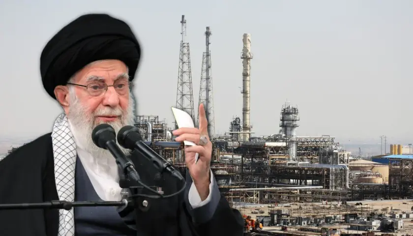 Ajatollah Chamenei przemawia na tle kompleksu przemysłowego, symbolizującego gospodarkę i **iran ludność**.